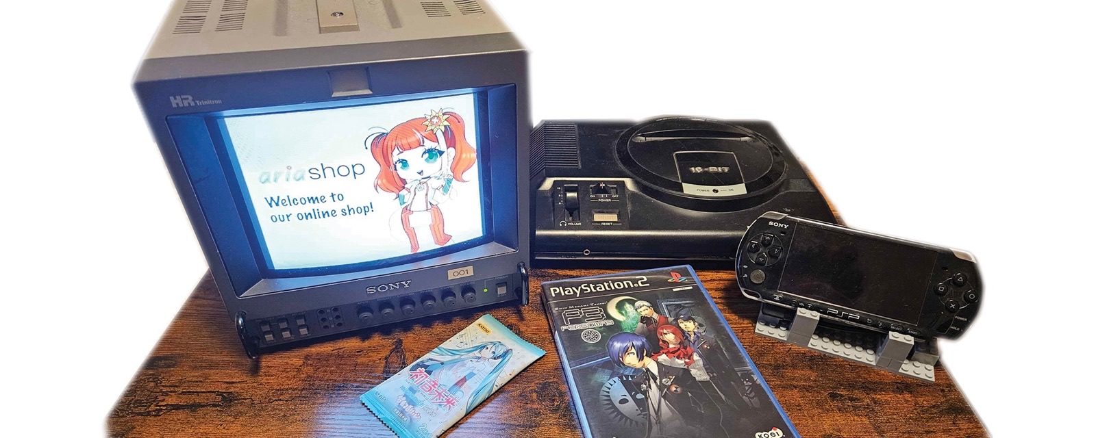 Welcome to Ariashop: a Sony monitor showing the Ariashop mascot, next to a Mega Drive, a PSP and Persona 3 for PlayStation 2